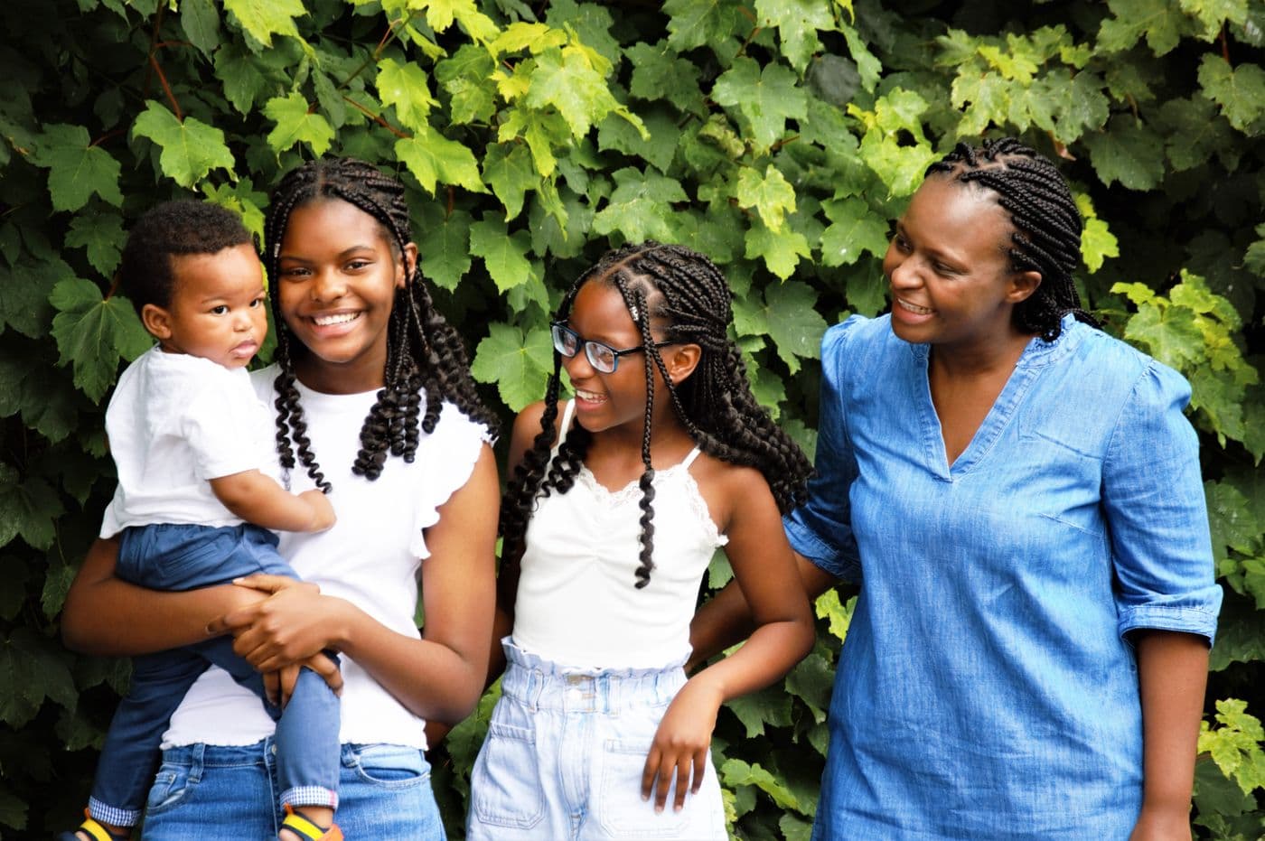 A mother and her children smiling together outdoors